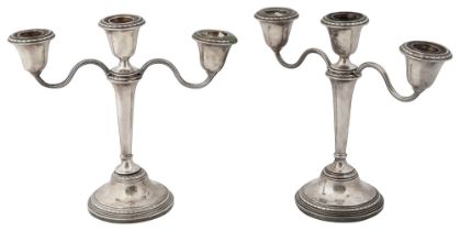 A pair of Elizabeth II silver three light candelabra