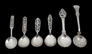 Four Norwegian .830 silver caddy spoons, a sifter spoon and another spoon