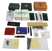 A collection of spare watch boxes, straps and accessories