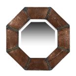 An Arts and Crafts octagonal copper wall mirror