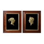 Two Victorian framed brass profile portraits of Queen Victoria and Prince Albert