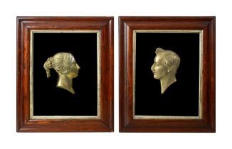 Two Victorian framed brass profile portraits of Queen Victoria and Prince Albert