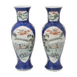 A pair of Chinese powder blue ground famille verte vases