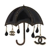 A black enamel and black crystal set umbrella pin by Chanel