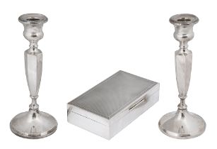 An Elizabeth II silver table cigarette box and a pair of candlesticks