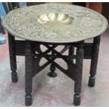 Good quality indian brass topped cairo table on heavily carved supports. App. 57cm H x 77cm Diameter