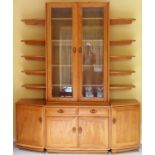 Ercol Golden Dawn light oak wall unit with shelves, sectional cupboard doors and drawers below. App.