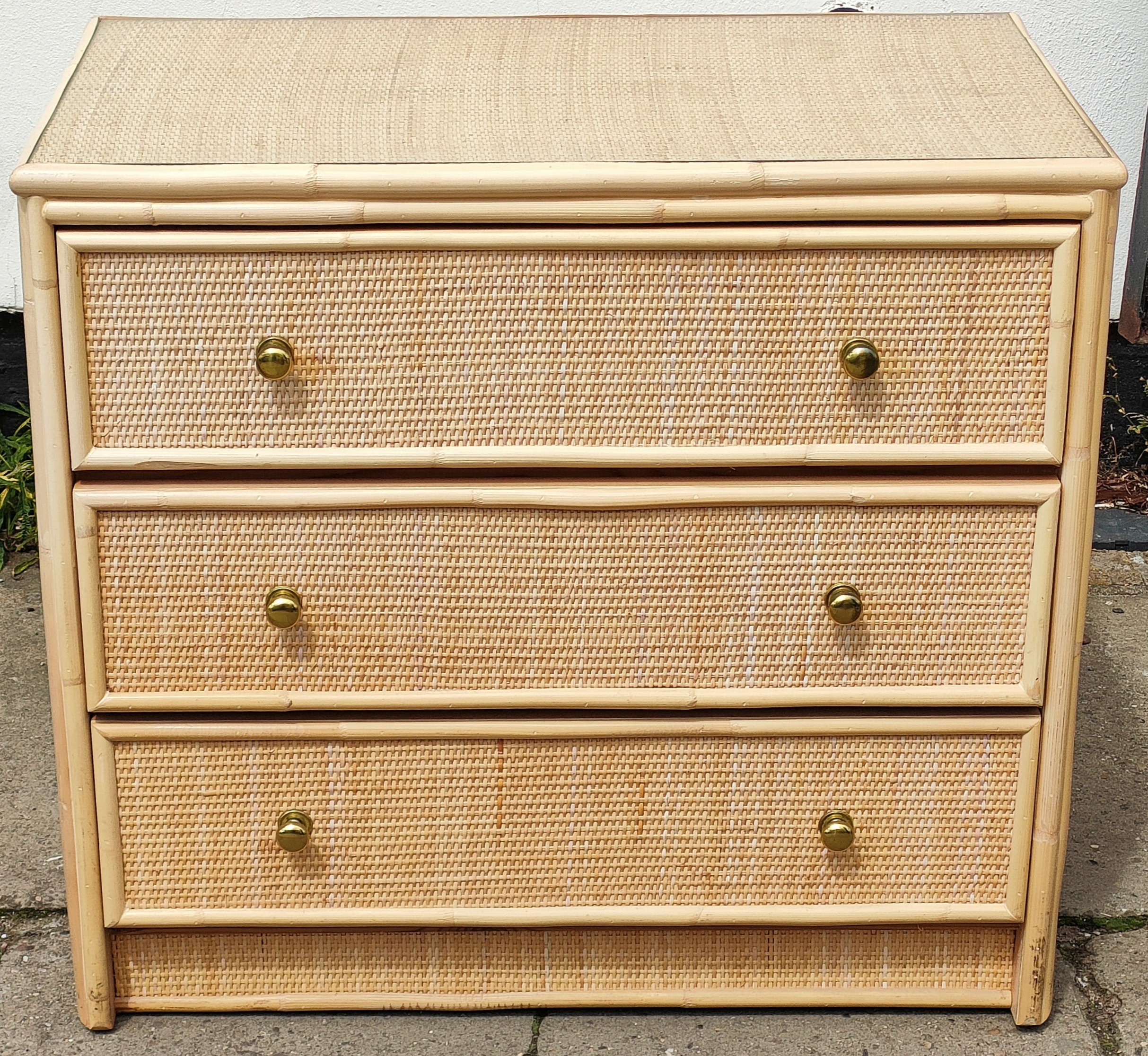 Three drawer rattan style chest of drawers. App. 72cm H x 79cm W x 45.5cm D Reasonable used