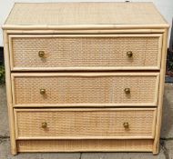 Three drawer rattan style chest of drawers. App. 72cm H x 79cm W x 45.5cm D Reasonable used