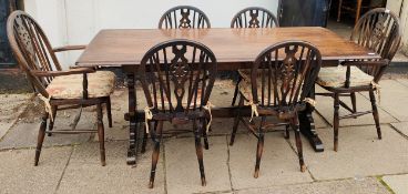 Ercol style oak refectory style table, plus six (4+2) wheel back chairs. Table App. 75cm H x 183cm W