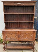 Oak Welsh style dresser with plate rack and cupboard doors below. App. 197cm H x 137cm W x 47.5cm