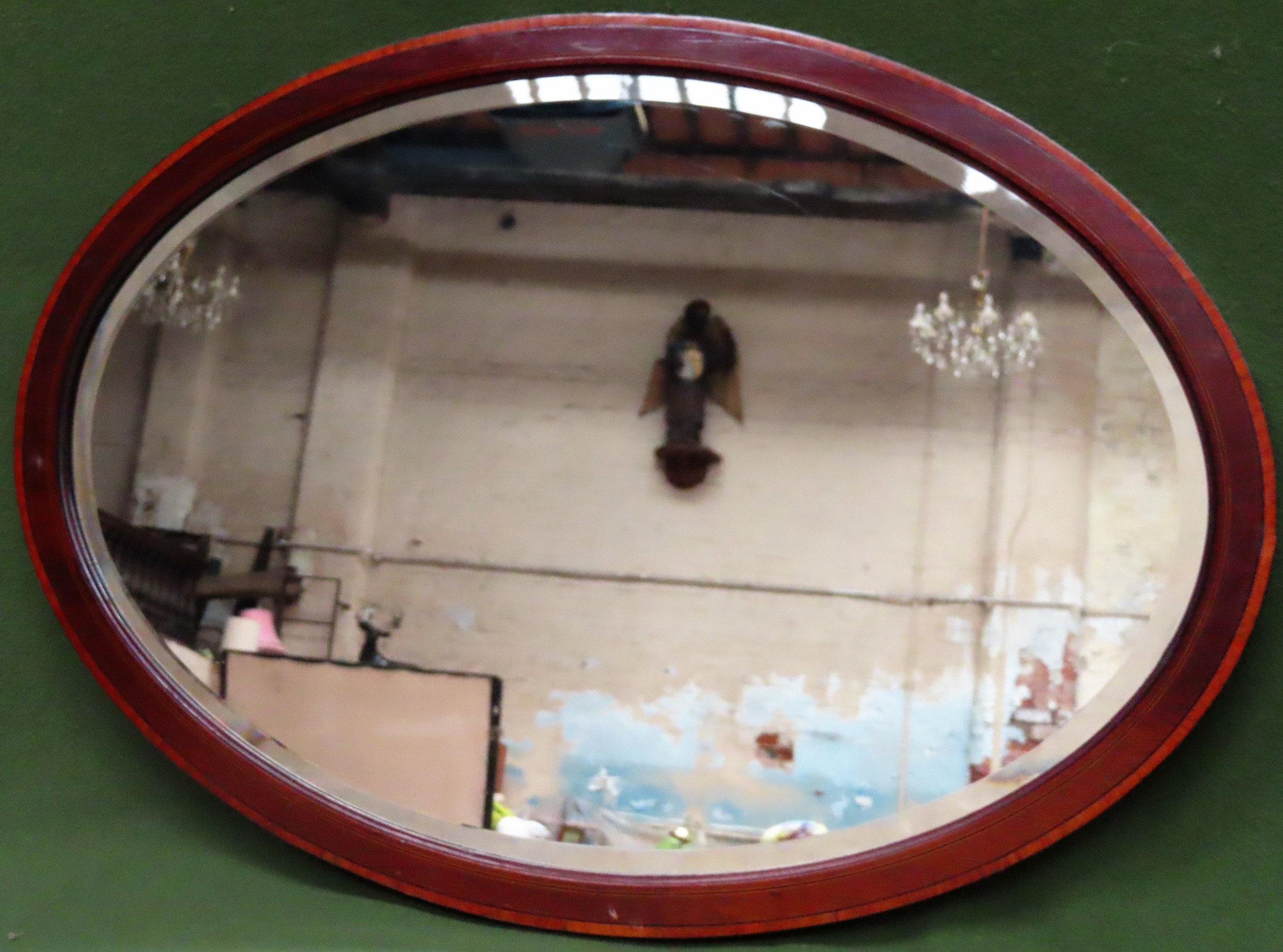 Mahogany bevelled and inlaid oval wall mirror. App. 57 x 82cm Reasonable used condition