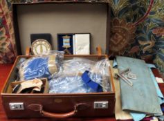 Case containing Masonic regalia including aprons, silver gilt jewel, accesories etc