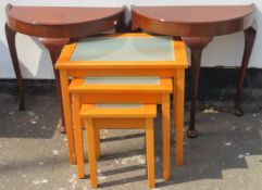 Pair of mahogany half moon tables, plus glass topped nest of three tables