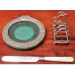 Small silver photo frame, mother of pearl handled knife, plus silver? toast rack