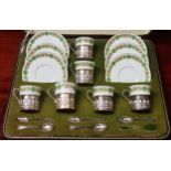 Cased set of Six Shelley coffee cups and saucers, with hallmarked silver mounts, plus spoons