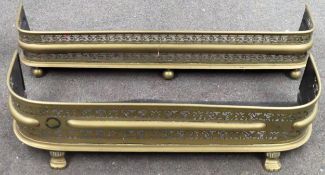 Two vintage brass piercework decorated fire kerbs, one with claw supports