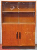 Art Deco oak bookcase with cupboard doors below. Approx. 131cm H x 91cm W x 25.5cm D