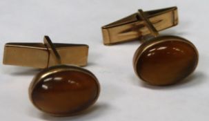 Pair of 9ct gold cufflinks, set with Tiger's eye style stones. Total weight 7.8g Both appear in