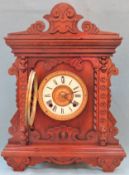 Early 20th century carved fronted Oak Ansonia American mantle clock, with circular enamelled dial.