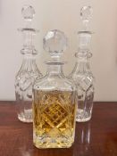 A PAIR OF GLASS DECANTERS PLUS ONE OTHER, APPROX 33cm HIGH AND 26cm