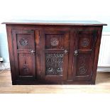 CARVED OAK THREE DOOR CUPBOARD BEARING PANEL 1642, APPROX 132cm LONG, 90cm HIGH AND 38cm DEEP