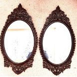 PAIR OF HIGH QUALITY CARVED OAK PIERCEWORK DECORATED OVAL WALL MIRRORS