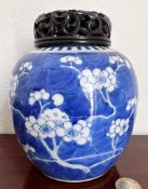 JAPANESE PRUNUS PATTERN JAR WITH WOODEN PIERCEWORK DECORATED COVER, APPROX 14cm HIGH HAIRLINE