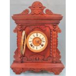 Early 20th century carved fronted Oak Ansonia American mantle clock, with circular enamelled dial.