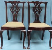 Pair of mahogany piercework decorated dining chairs on cabriole supports. Approx. 98cms H