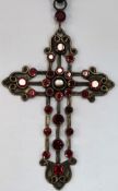 Large 925 silver piercework decorated cross pendant set with ruby coloured stones, on chain
