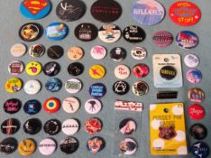 Various badges including Nirvana, The Who, Star Wars, The Cure, etc