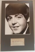 Paul McCartney signature on lined paper mounted with black & white photograph.