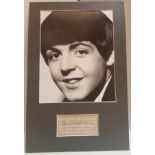 Paul McCartney signature on lined paper mounted with black & white photograph.