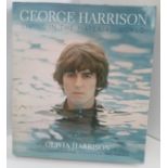 George Harrison Living In The Material World book signed by Olivia Harrison.