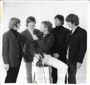 Four original photographs of The Beatles, two from The Beatles Christmas Show and marked on