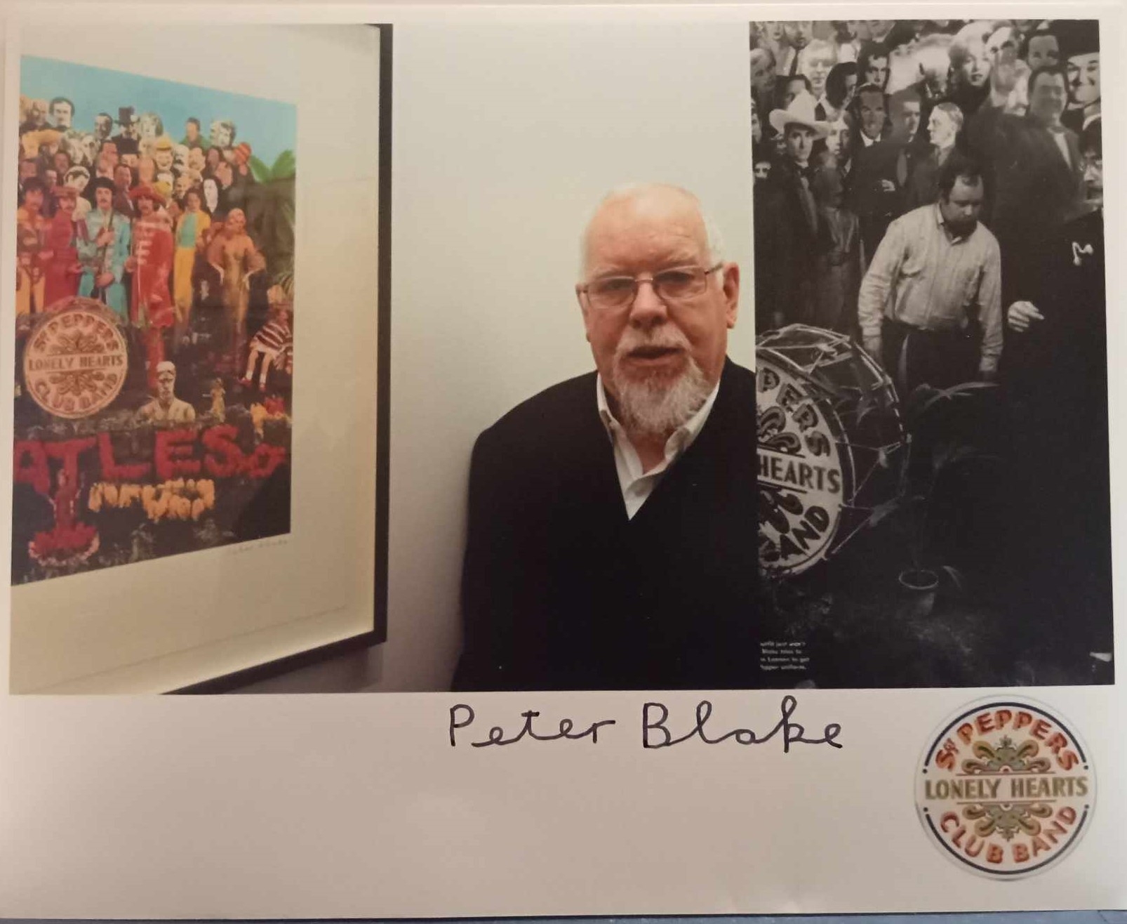 Peter Blake signed photograph of him with various Sgt Pepper images