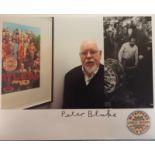 Peter Blake signed photograph of him with various Sgt Pepper images