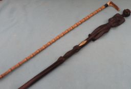 Interesting hand carved tribal style walking stick, plus another walking stick. Approx. 96cms L