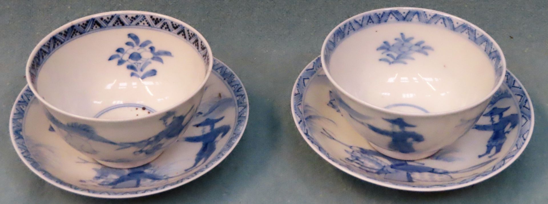 Two similar Oriental blue and white glazed ceramic tea bowls and saucers reasonable used condition