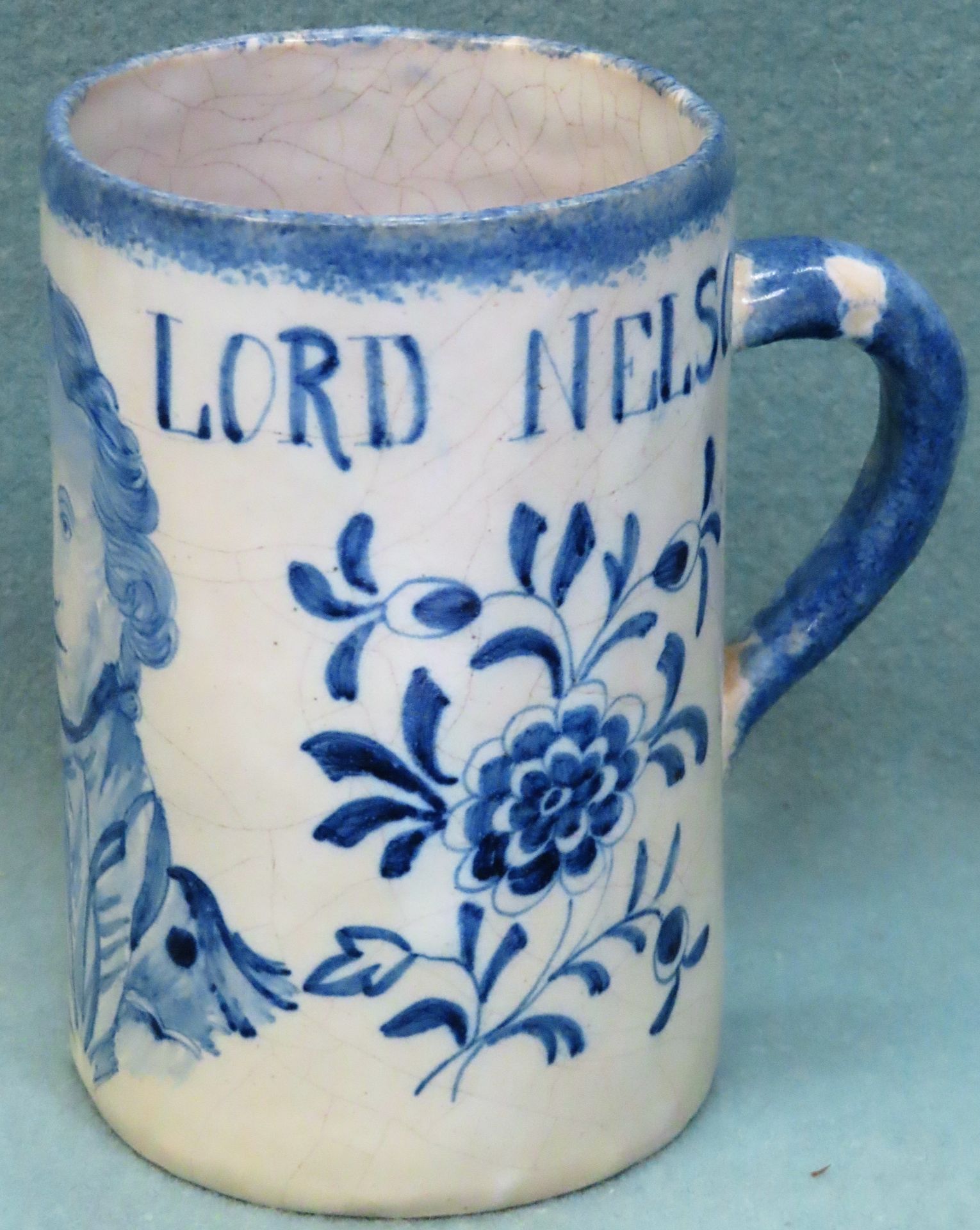 Early 19th century English Delft pottery tankard, decorated with a bust of Lord Nelson and inscribed