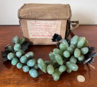 WORLD WAR II GAS MASK AND TWO BUNCHES OF GLASS GRAPES