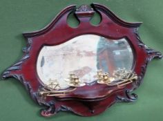 Carved mahogany bevelled wall mirror, with compostie brass piercework sconces. Approx. 55 x 76cms