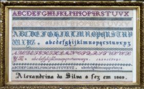 Gilt framed 1869 sampler. Approx. 35 x 57.5cms reasonable used with minor stains. frame chipped in