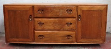 Ercol Golden Dawn three drawer sideboard. Approx. 69 x 155 x 43cms used with scuffs scratches and