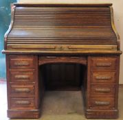 Early 20th century oak roll top writing desk on pedestal supports. Approx. 128 x 126 x 88cms