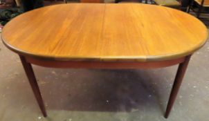 G-Plan mid 20th century teak extending dining table with fold out leaf. Approx. 74 x 209 cms