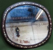 Late 19th/early 20th century oval wall mirror with mother of pearl inlaid decoration. Approx. 56.