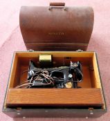 Two vintage cased Singer sewing machines used and not tested. one case is locked