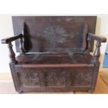 19th century dark oak monks bench with lift up seat and carved decoration. Approx. 99 x 122 x